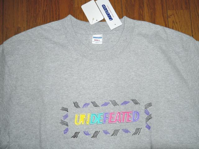 �V�i UNDEFEATED �A���f�B�t�B�[�e�b�h T�V���c S �D �O���f�[�V���� LOGO���S OUTLINE S/S TEE �� �u�����h�� 